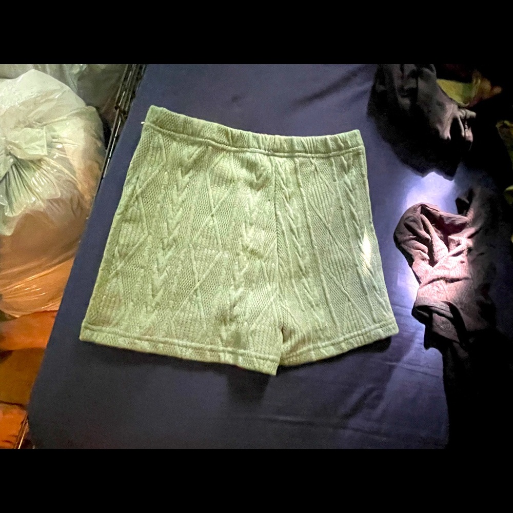 Green shorts with designs on them